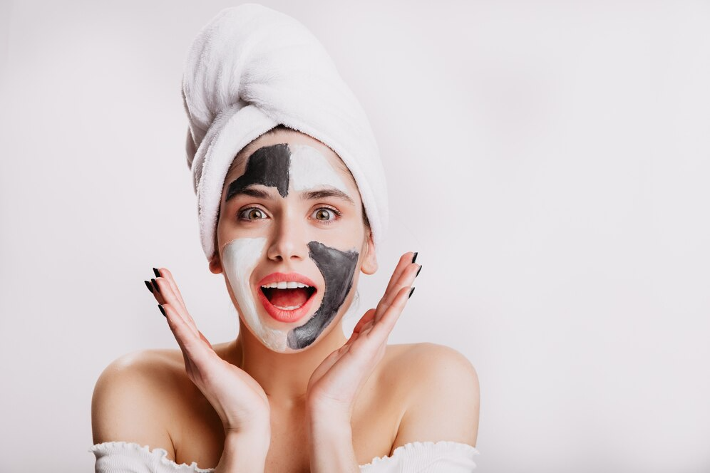 joyful girl with face mask surprise green eyed woman posing white wall after washing her hair_197531 13982